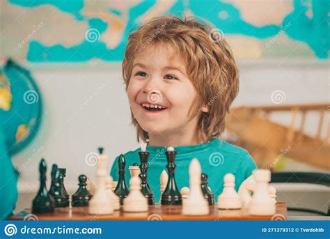 Young Kid Boy Playing Chess And Having Fun Cheerful Smiling Little Boy