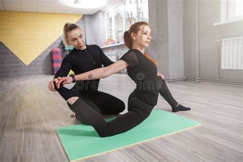 Yoga Instructor Helping Her Client In Class Stock Photo Image Of Helping Profession