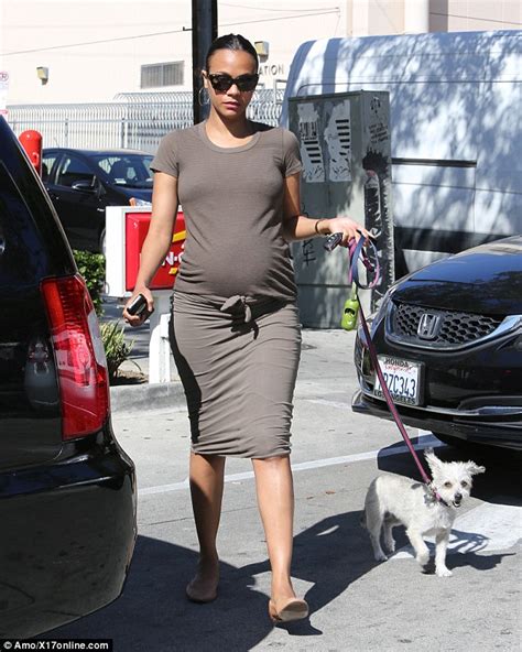 zoe saldana indulges her pregnancy cravings with a burger as she shows off huge bump in a tight