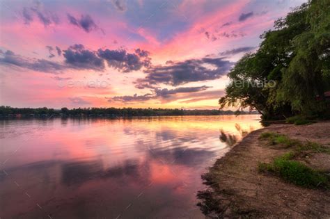 Tranquil Scene With River And Colorful Sky With Clouds At Sunset Stock