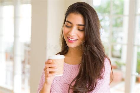Beautiful Young Girl Drinking A Cup Of Coffee At Home And Smiling Stock
