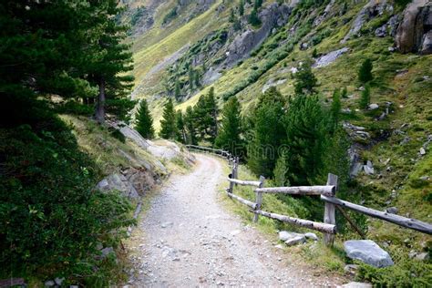 Rocky Trail Leading To Valley Surrounded By High Mountains In Swiss