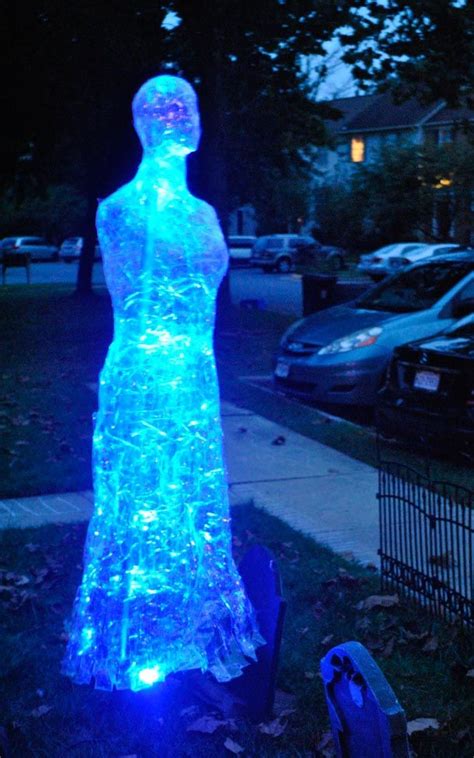 A Statue Made Out Of Plastic Sitting On Top Of A Grass Covered Field