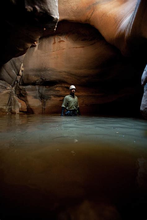 A Man Wades Through Deep Stagnant Water Photograph By Christopher