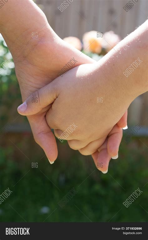 Two Girls In Love Holding Hands