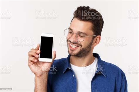 Young Man Showing His Brand New Smart Phone Isolated On White Stock