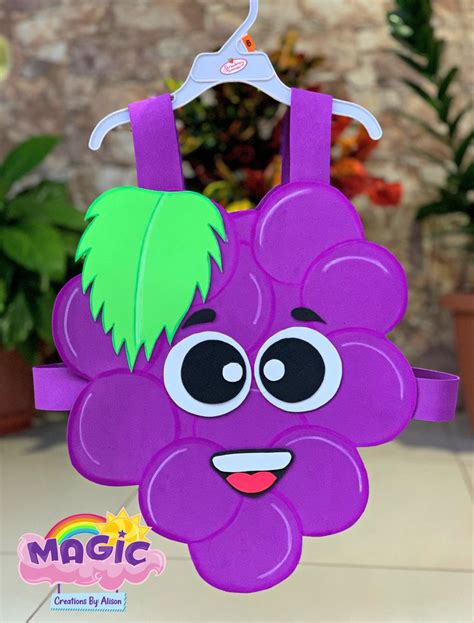 A Purple Paper Bag With A Green Leaf Hanging From It S Handle And Eyes