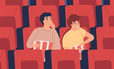 jovem surpreso e interessado meninos no cinema comendo pipoca na sala de cinema vazia amigos