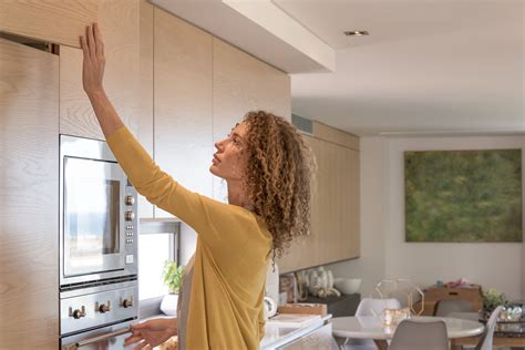 You can see how the dark cabinets with the furr down (or soffit) above, make for a long, horizontal boring wall with the feel of a low ceiling. When Should Cabinetry Go to the Ceiling?