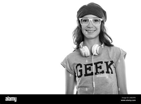 Studio Shot Of Happy Geek Girl Smiling And Wearing Eyeglasses With