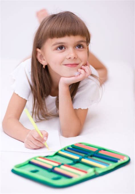 Little Girl Drawing Using Color Pencils Laying Floor Stock Photos