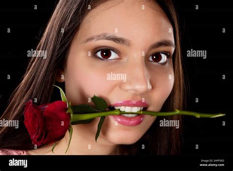 Pretty Woman Holding A Red Rose In Her Mouth Stock Photo Alamy