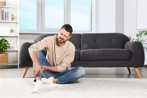 Man Suffering From Leg Pain At Home Space For Text Stock Image Image