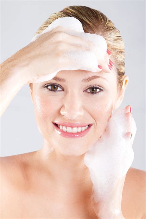 Woman Washing Her Face With A Foam Holos Skincare