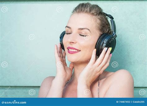 Beautiful Woman Wearing Headphones And Enjoying Music Stock Image