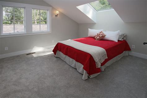 Large Windows And Skylights Brighten This Second Floor Bedroom For