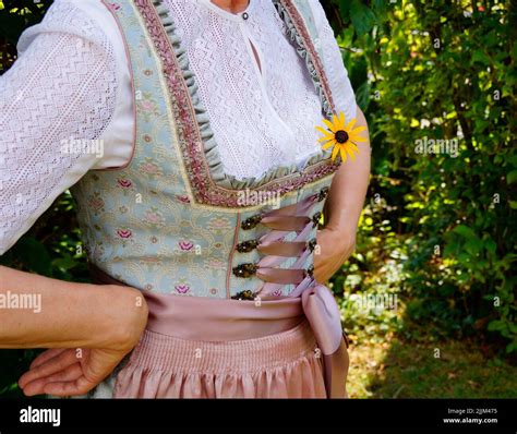 A Woman In A Beautiful Traditional Bavarian Dirndl Dress At The