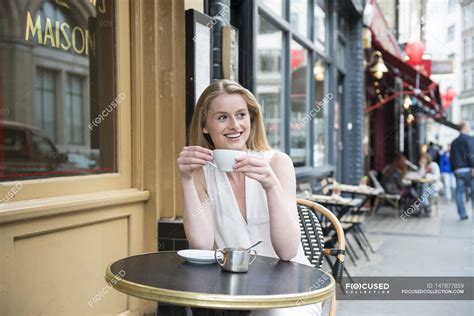 Woman sitting outside cafe — place, england - Stock Photo ...