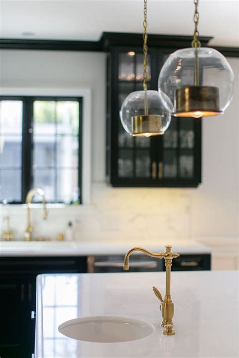 The kitchen features white cabinets, black countertops, black hardware, matte black faucet cosmic black granite has white and gold veins and black galaxy granite is solid black with white speckles. Top 5 Home Design Trends for 2015 - Zillow Porchlight
