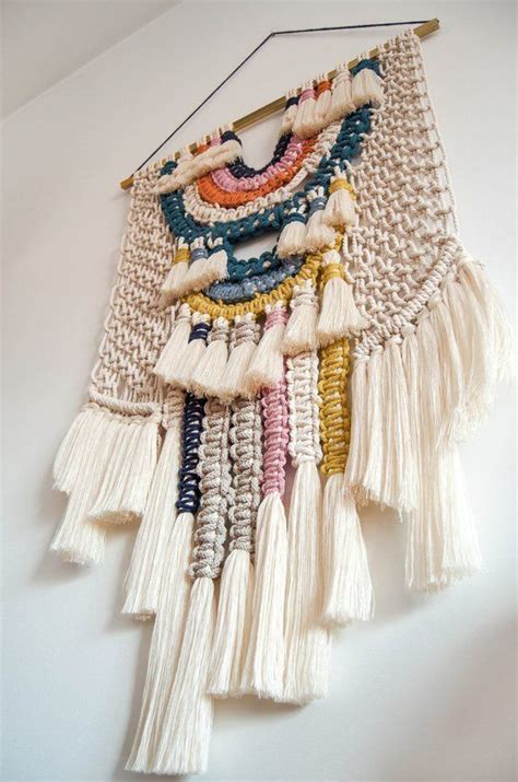 A White Wall Hanging With Tassels And Beads