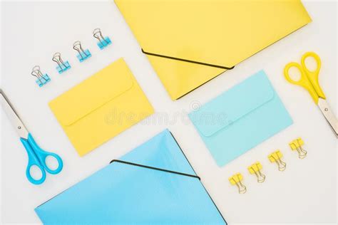 Blue Scissors Paper Clips Folder And Pen On Yellow Envelope Near