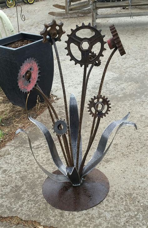 there is a metal sculpture made to look like gears and flowers on the