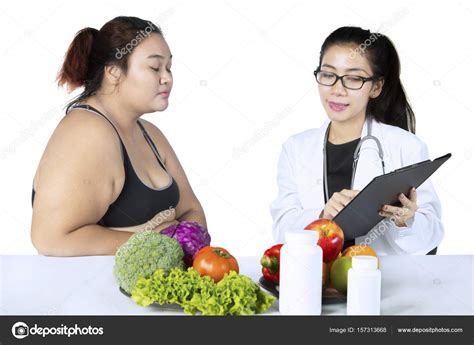 Doctor With Clipboard And Obese Patient Stock Photo Realinemedia