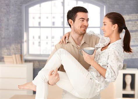 Happy Man Holding Woman In His Arms Smiling Stock Image