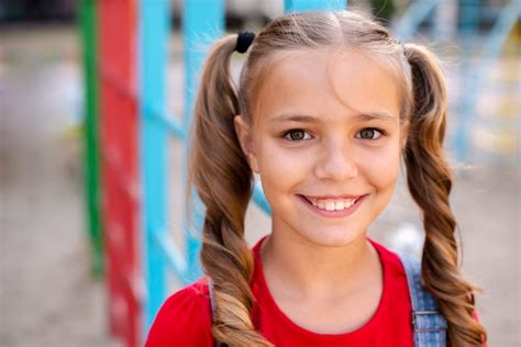 Free Photo Smiley Girl With Blond Hair Looking At Camera
