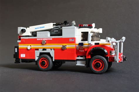 A Lego Fire Truck Is Shown On A Black Background With Red Rims And Wheels