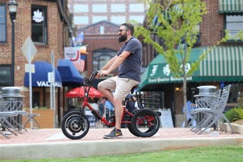 I'ts got a small electric motor, two rear wheels and a basket for carrying stuff. Liberty Trike: 3-wheel electric bike for adults - Device-Boom