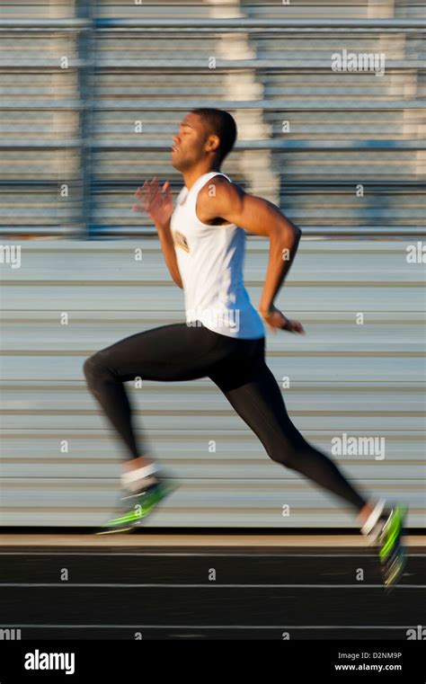 African American Black Track Runner Sprinter In Stride Stock Photo