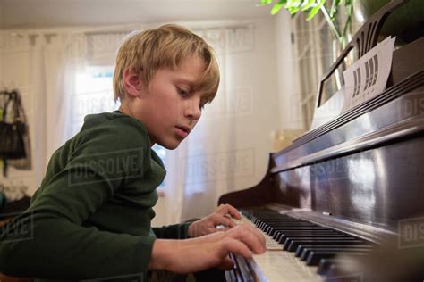 Boy Playing Piano In Living Room Stock Photo Dissolve
