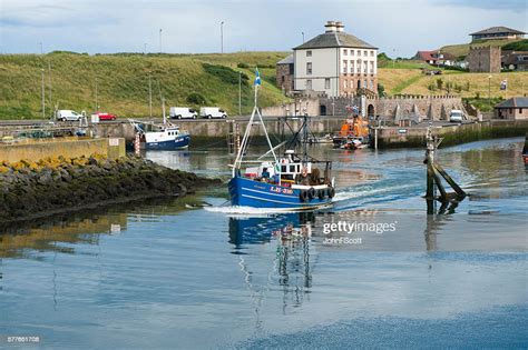 Fishing Boat Leaving Eyemouth Harbour In South East Scotland High Res
