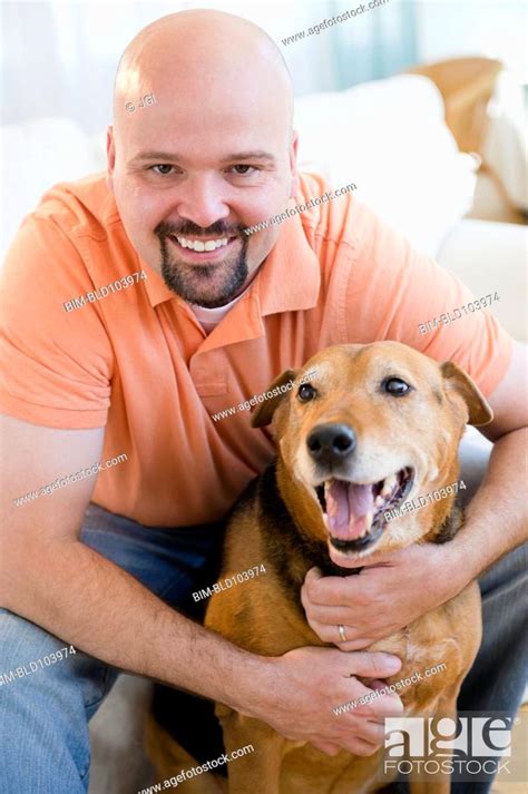 Smiling Man Hugging Dog Stock Photo Picture And Royalty Free Image