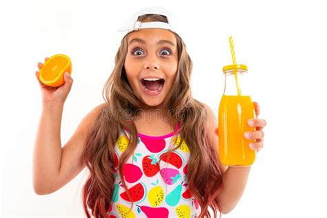 A Funny Girl With Long Hair Swimsuit White Cap Holds Orange Halve
