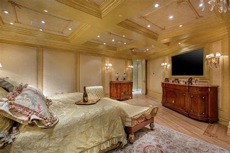 Luxurious Master Bedroom With Gold Decor Chaise Lounge And Rich Wood
