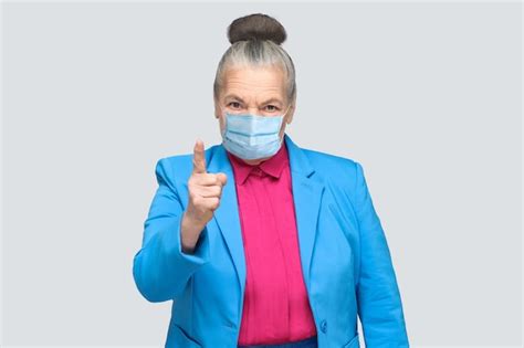 Premium Photo Angry Aged Woman With Surgical Medical Mask Warning You