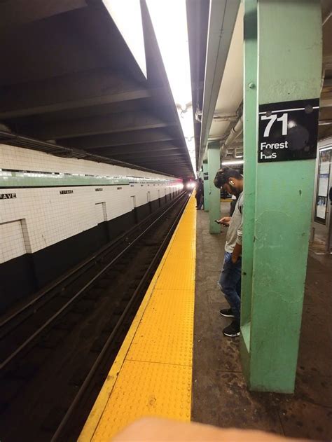 M Train Arriving At 71st Continental Forest Hills Station Nyc