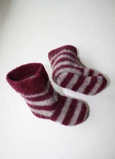 Two Pairs Of Striped Slippers Sitting On Top Of A White Table Next To