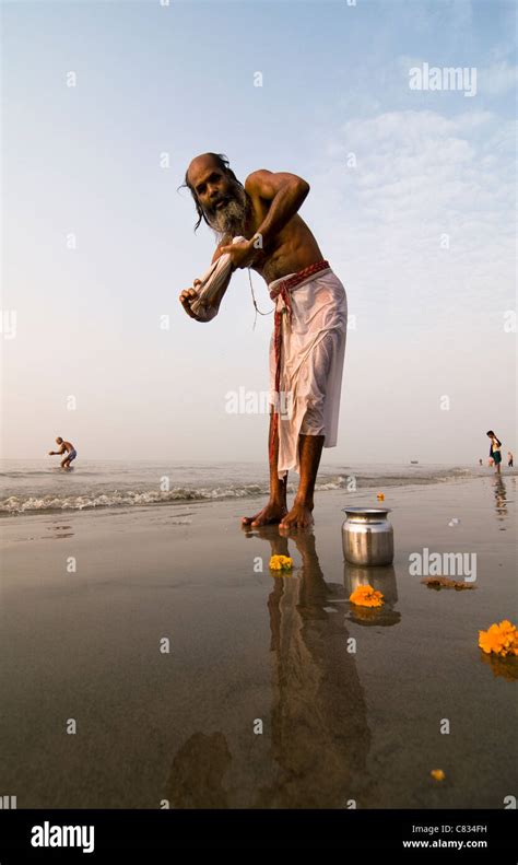 An Indian Pilgrim Bathing In The Holy Water Of Gangasagar Stock Photo