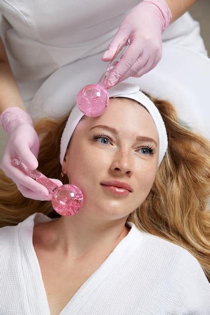 Premium Photo Young Woman Receiving Facial Massage With Glass Balls