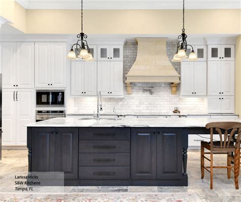 An easy way to highlight dark wood is contrasting it with white. Kitchen with White Cabinets and a Gray Island - Omega