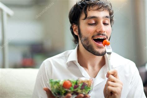 Young Man Eating A Healthy Salad — Stock Photo © Minervastock 30020603