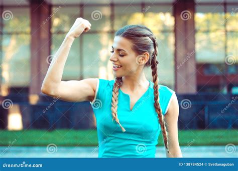 Smiling Woman Showing Bicep Stock Photo Image Of Confident Outdoors