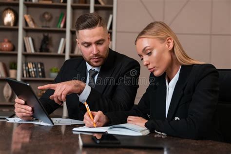 Business People Working Together With Tablet And Taking Notes Stock