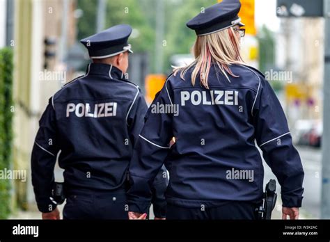 germany police officer woman two police patrol germany policeman police officers rear view