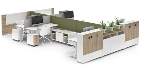 An Office Cubicle With Desks Chairs And Computers