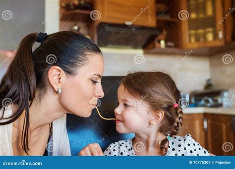Mother And Daughter In The Kitchen Eating Spaghetti Together Stock Image Image Of Love