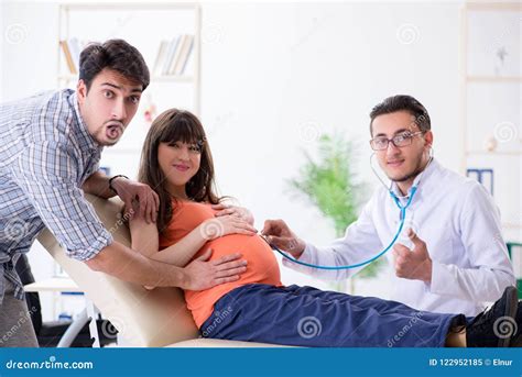 The Pregnant Woman With Her Husband Visiting The Doctor In Clinic Stock Image Image Of Doctor